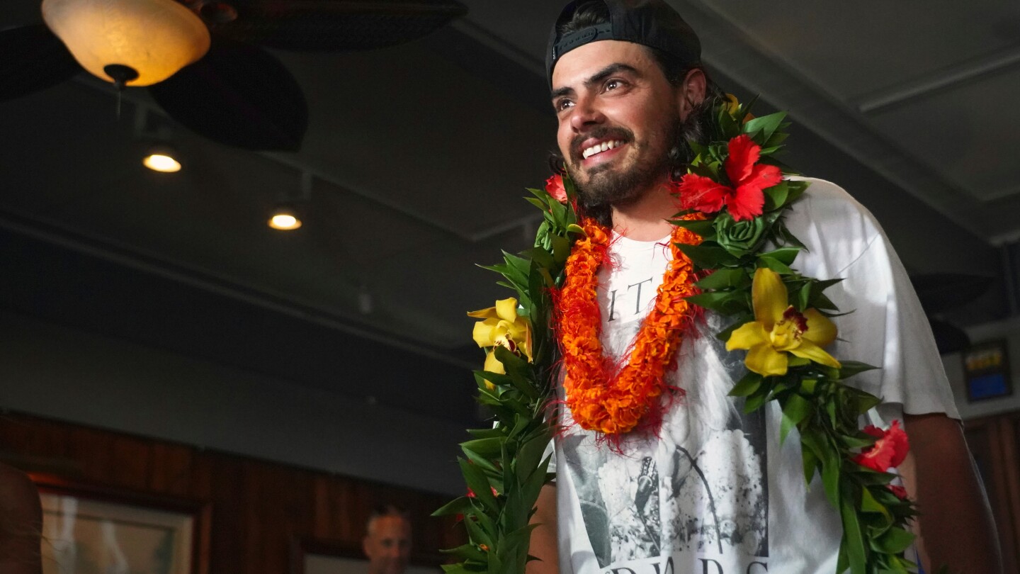An Oregon man who quit his job to set sail with his cat arrives to cheering fans in Hawaii