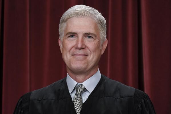 FILE - Associate Justice Neil Gorsuch joins other members of the Supreme Court as they pose for a new group portrait, at the Supreme Court building in Washington, Friday, Oct. 7, 2022. Gorsuch called emergency measures taken during the COVID-19 crisis that killed more than 1 million Americans perhaps “the greatest intrusions on civil liberties in the peacetime history of this country.” The 55-year-old conservative justice pointed to orders closing schools, restricting church services, mandating vaccines and prohibiting evictions in a broadside aimed at local, state and federal officials, even his colleagues. (AP Photo/J. Scott Applewhite, File)