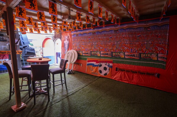 Some fans covered their garden and installed a screen to watch soccer matches as orange tarp, orange bunting, and Dutch national flags decorate Marktweg street in The Hague, Netherlands, Thursday June 13, 2024, one day ahead of the start of the Euro 2024 Soccer Championship. The Marktweg is one of several streets in the Netherlands that get an all-encompassing orange facelift during European Championships and World Cups when the national team, known as Oranje after the Dutch royal family and the color of their shirts, are playing. (AP Photo/Peter Dejong)