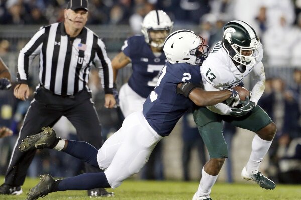 
              Penn State's Donovan Johnson (2) tackles Michigan State's Laress Nelson (13) after a catch during the second half of an NCAA college football game in State College, Pa., Saturday, Oct. 13, 2018. (AP Photo/Chris Knight)
            
