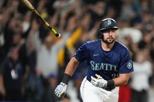 Seattle Mariners' Cal Raleigh flips his bat after hitting a game-winning grand slam against the Chicago White Sox during the ninth inning of a baseball game Monday, June 10, 2024, in Seattle. (AP Photo/Lindsey Wasson)