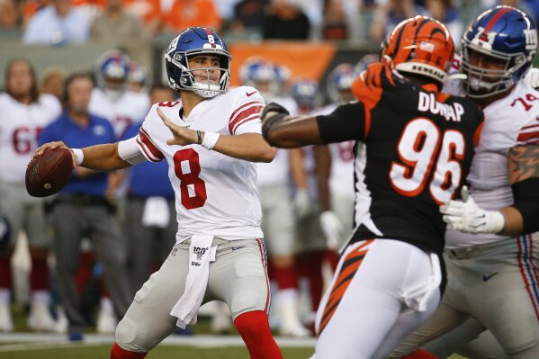 FILE - In this Aug. 22, 2019, file photo, New York Giants quarterback Daniel Jones (8) looks for a receiver during the first half of an NFL preseason football game against the Cincinnati Bengals in Cincinnati. Eli Manning's long and distinguished reign as the New York Giants' starting quarterback is seemingly over. Let the Daniel Jones era begin. Coach Pat Shurmur announced Tuesday, Sept. 17, 2019, that the No. 6 overall pick in the NFL draft is replacing two-time Super Bowl MVP as the Giants' quarterback, beginning Sunday at Tampa Bay.(AP Photo/Frank Victores, File)