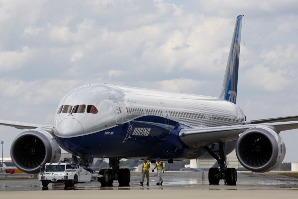 FILE - In this Friday, March 31, 2017, file photo, Boeing employees walk the new Boeing 787-10 Dreamliner down towards the delivery ramp area at the company's facility in South Carolina after conducting its first test flight at Charleston International Airport in North Charleston, S.C. Boeing, on Friday, March 15, 2024 is telling airlines to inspect switches on pilots' seats in its 787 Dreamliner jets after a published report said an accidental cockpit seat movement likely caused the sudden plunge of a LATAM Airlines plane flying to New Zealand.(AP Photo/Mic Smith, File)
