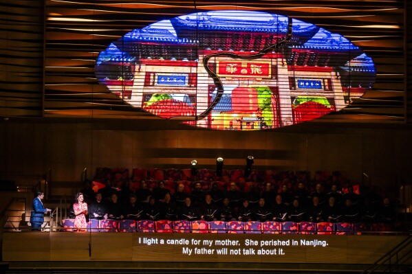 This image released by the New York Philharmonic shows Long Yu conducting a performance of Aaron Zigman’s "Émigré," at David Geffen Hall in New York on Thursday, Feb. 29, 2024. (Chris Lee/New York Philharmonic via AP)