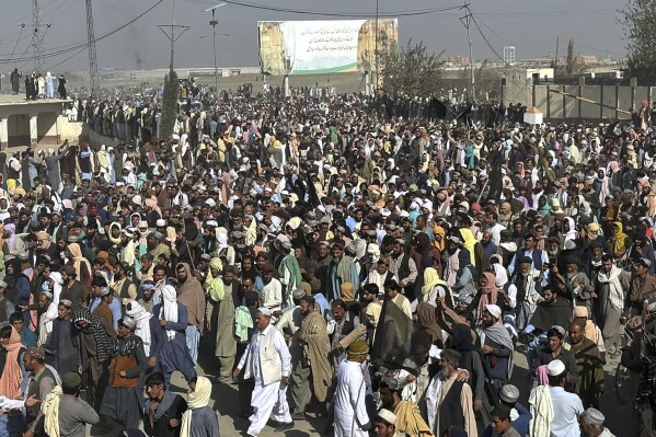 FILE - Local residents and Afghan nationals chant slogan during a protest rally in the southwestern border town of Chaman, Pakistan, Oct. 26, 2023. U.N. agencies say there has been a sharp increase in Afghans returning home since Pakistan launched a crackdown on migrants who are in the country illegally. The policy targets all undocumented or unregistered foreigners, according to the government. (AP Photo)