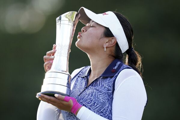 Lilia Vu of the US celebrates victory with the trophy on day four of the 2023 AIG Women's Open at Walton Heath, in Surrey, England, Sunday Aug. 13, 2023. (John Walton/PA via AP)
