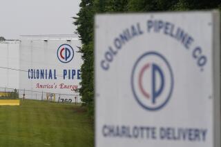 The entrance of Colonial Pipeline Company is shown Wednesday, May 12, 2021, in Charlotte, N.C.  Several gas stations in the Southeast reported running out of fuel, primarily because of what analysts say is unwarranted panic-buying among drivers, as the shutdown of a major pipeline by hackers entered its fifth day.  (AP Photo/Chris Carlson)