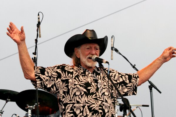 FILE - In this July 4, 2006, file photo, Willie Nelson addresses fans attending his Fourth of July Picnic in Ft. Worth, Texas. Willie Nelson’s annual Fourth of July Picnic is going ahead this year,...