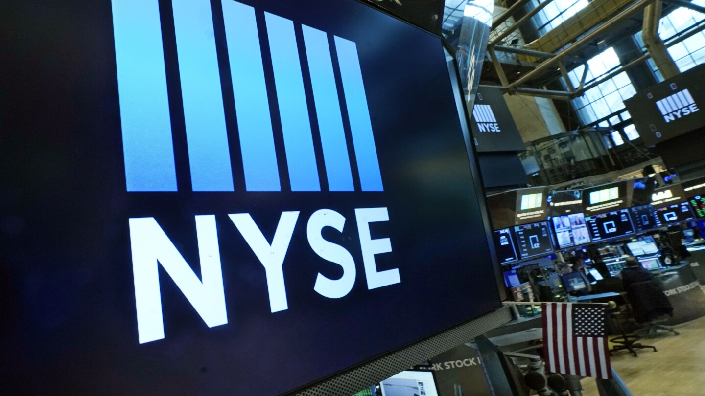 FILE - Logos the New York Stock Exchange adorn trading posts, on the floor, Wednesday, March 16, 2022. Stocks are off to mixed start on Wall Street, T