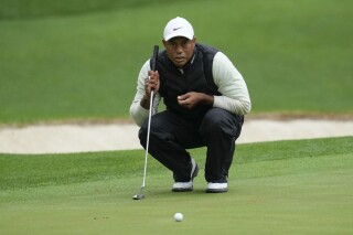 FILE - Tiger Woods lines up a putt on the 16th hole during the weather delayed second round of the Masters golf tournament at Augusta National Golf Club Saturday, April 8, 2023, in Augusta, Ga. Woods says his right ankle that was fused in April is pain-free, but other parts of his leg are not. (AP Photo/Mark Baker, File)