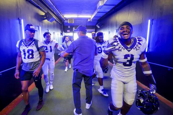 TCU head coach Sonny Dykes, center, congratulates players following a victory over SMU in an NCAA college game on Saturday, Sept. 24, 2022, in Dallas, Texas. (AP Photo/Gareth Patterson)