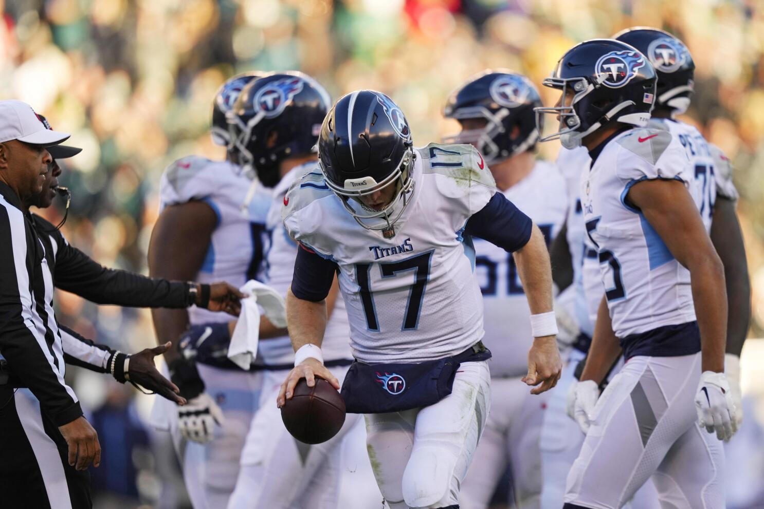 Ryan Tannehill of the Tennessee Titans runs the ball and is chased