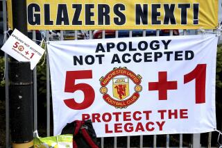 Banners near the stadium as fans protest against the Glazer family, owners of Manchester United, before their Premier League match against Liverpool at Old Trafford, Manchester, England, Sunday, May 2, 2021. (Barrington Coombs/PA via AP)