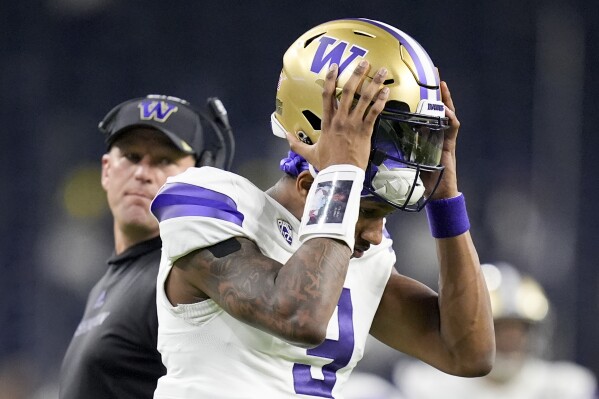 Washington quarterback Michael Penix Jr. leaves field at the end of the half against Michigan of the national championship NCAA College Football Playoff game Monday, Jan. 8, 2024, in Houston. (AP Photo/Eric Gay)