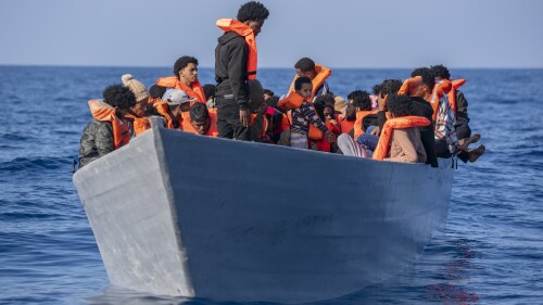 Migrants from Eritrea, Libya and Sudan crowd the deck of a wooden boat as they wait to be assisted by aid workers of the Spanish NGO Open Arms, in the Mediterranean sea, about 30 miles north of Libya, Saturday, June 17, 2023. (AP Photo/Joan Mateu Parra)