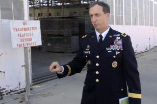 FILE - In this Oct. 23, 2015 photo, U.S. Army Brig. Gen. Mark Martins, the chief prosecutor at the U.S. military commission at Guantanamo Bay, Cuba, speaks during a break in pretrial proceedings for the five men charged with planning and aiding the Sept. 11 attack. Martins, who spent the past decade leading an oft-stalled effort to prosecute five men for the Sept. 11 terrorist attacks at the Guantanamo Bay naval station, is retiring from the military, leaving his post as chief prosecutor as a trial in the case remains elusive.(AP Photo/Ben Fox, File)