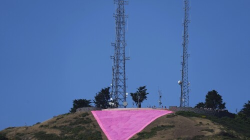 A pink triangle is seen on top of Twin Peaks in San Francisco, Tuesday, June 20, 2023. Hundreds of volunteers installed the giant pink triangle made out of cloth and canvas and with pink lights around its edges last week as part of the city's Pride celebrations. It's an annual tradition that started in 1995 but this year's triangle is nearly an acre in size and can be seen up to 20 miles (32 kms.) away. (AP Photo/Jeff Chiu)