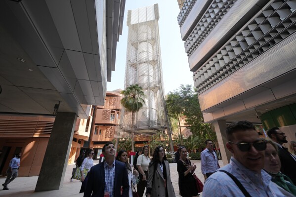 People visit Masdar City near Abu Dhabi, United Arab Emirates, as Dubai hosts the COP28 U.N. Climate Summit, Friday, Dec. 8, 2023. (AP Photo/Kamran Jebreili)