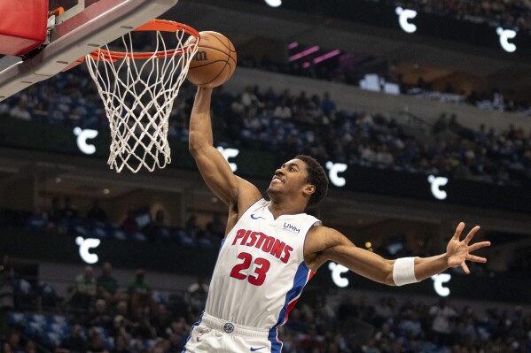 Detroit Pistons guard Jaden Ivey dunks during the first half of an NBA basketball game against the Dallas Mavericks, Friday, April 12, 2024, in Dallas. (AP Photo/Jeffrey McWhorter)