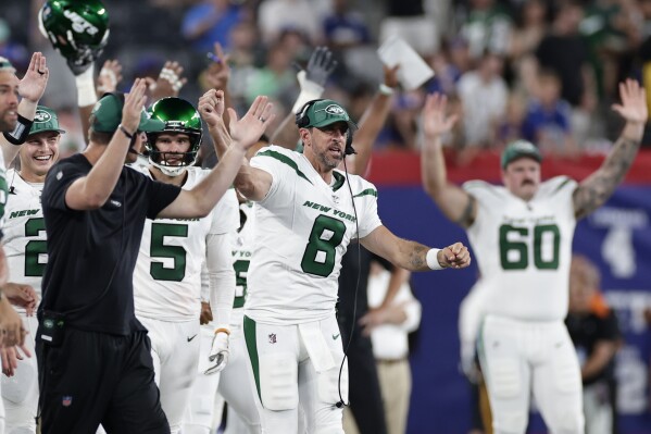 New York Jets quarterback Aaron Rodgers (8) reacts to a touchdown during the second half of an NFL preseason football game against the New York Giants, Saturday, Aug. 26, 2023, in East Rutherford, N.J. (AP Photo/Adam Hunger)