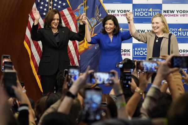 Vice President Kamala Harris, left, New York Gov. Kathy Hochul, center, and former Secretary of State Hillary Clinton, stand together on stage during a campaign event for Hochul, Thursday, Nov. 3, 2022, at Barnard College in New York. (AP Photo/Mary Altaffer)