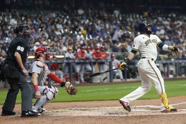 Milwaukee Brewers' Carlos Santana hits and RBI double during the third inning of a baseball game against the St. Louis Cardinals Tuesday, Sept. 26, 2023, in Milwaukee. (AP Photo/Morry Gash)