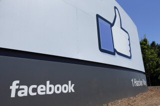 FILE - This July 16, 2013 file photo shows a sign at Facebook headquarters in Menlo Park, Calif. Facebook said Thursday, May 16, 2019, that it has banned Archimedes, an Israeli company that ran an influence campaign aimed at disrupting elections in various countries, and has canceled dozens of accounts engaged in spreading disinformation. Nathaniel Gleicher, Facebook’s head of cybersecurity policy, told reporters that the tech giant had purged 65 Israeli accounts, 161 pages, dozens of groups and four Instagram accounts. (AP Photo/Ben Margot, File)