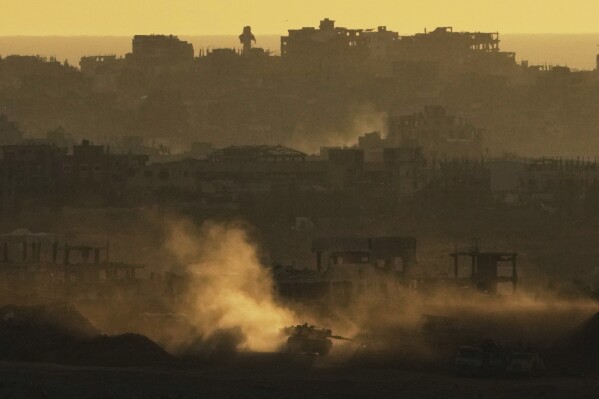 An Israeli army tank maneuvers in the Gaza Strip is seen from southern Israel, Sunday, May 4, 2025. (AP Photo/Ariel Schalit)