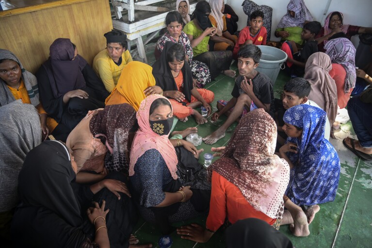 Rohingya refugees rest on the deck of a National Search and Rescue Agency ship, after being rescued from their capsized boat off West Aceh, Indonesia, on Thursday, March 21, 2024. The wooden fishing boat carried about 140 Rohingya refugees, but only 75 people were rescued. In interviews with The Associated Press, eight of the survivors described abuses on board the fishing boat. (AP Photo/Reza Saifullah)
