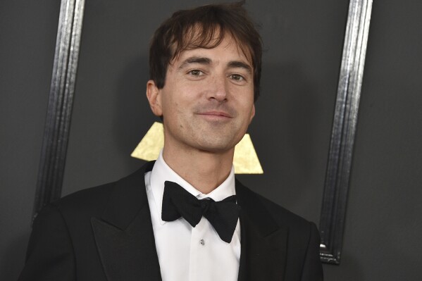FILE - Mason Bates arrives at the 59th annual Grammy Awards at the Staples Center on Sunday, Feb. 12, 2017, in Los Angeles. The Los Angeles Opera scrapped plans for the world premiere of Bates' “The Amazing Adventures of Kavalier & Clay” this fall because of finances, and the work will instead open with a student cast at Indiana University's Jacobs School of Music. (Photo by Jordan Strauss/Invision/AP, File)