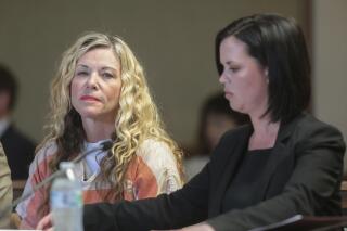 CORRECTS CHARGE TO MURDER CONSPIRACY- File- This March 6, 2020, file photo shows Lori Vallow Daybell, left, glancing at the camera during her hearing on in Rexburg, Idaho. Daybell, who is already charged in Idaho with murder conspiracy in the deaths of her daughter and son, was charged in Arizona on Thursday, June 24, 2021, with conspiring to murder her ex-husband Charles Vallow in 2019. (John Roark/The Idaho Post-Register via AP, Pool,File)
