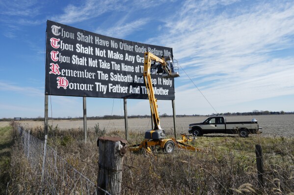 FILE - Workers repaint a Ten Commandments billboard off of Interstate 71 on Election Day near Chenoweth, Ohio, Tuesday, Nov. 7, 2023. Louisiana has become the first state to require that the Ten Commandments be displayed in every public school classroom under a bill signed into law by Republican Gov. Jeff Landry on Wednesday. (AP Photo/Carolyn Kaster, File)