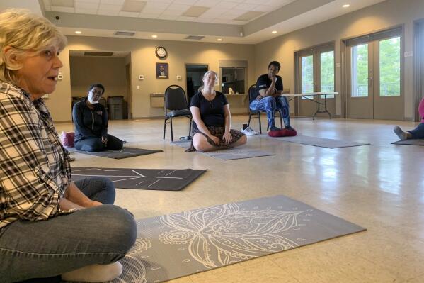 Participants in a six-week mindfulness course put on by East St. Tammany Habitat for Humanity and the Northshore Community Foundation gather in Slidell, La. (Kentrell Jones via AP)