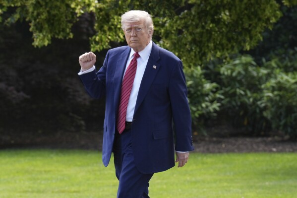 President Donald Trump gestures as he departs the White House, Friday, May 23, 2025, in Washington. (AP Photo/Jacquelyn Martin)