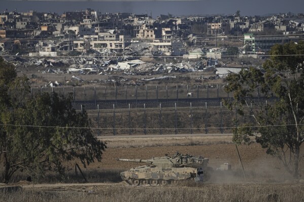 An Israeli armored vehicle transits around the Israel-Gaza border, as seen from southern Israel, Sunday Dec. 1, 2024. (AP Photo/Tsafrir Abayov)