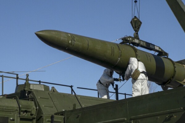 In this photo released by Russian Defense Ministry Press Service on Friday, Feb. 2, 2024, Russian troops load an Iskander missile onto a mobile launcher during drills at an undisclosed location in Russia. The Iskander is a short-range missile system that has been used by the Russian military in the fighting in Ukraine. (Russian Defense Ministry Press Service via AP)