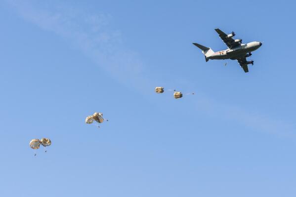 This photo provided by the French Army, soldiers taking part of the projection operation towards Estonia named Operation Thunder Lynx jump over Estonina territory as part of NATO missions in Estonia, early Wednesday June 22, 2022. About a hundred paratroopers from the French 11th Airborne Brigade were deployed above the Estonian territory. (French Army via AP)