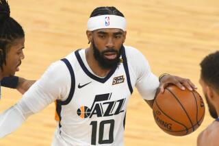 FILE - In this May 29, 2021, file photo, Utah Jazz guard Mike Conley is pressured by Memphis Grizzlies players during the second half of Game 3 of an NBA basketball first-round playoff series in Memphis, Tenn. Conley returned to Utah to help the Jazz finish what they started last season. Conley represents Utah’s biggest signing in free agency, agreeing to a three-year deal worth $68.04 million on the first day free agents could negotiate with NBA teams. (AP Photo/John Amis, File)