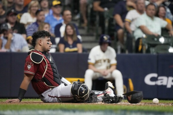 Arizona catcher Gabriel Moreno leaves Game 2 of Wild Card Series after  backswing hits his helmet