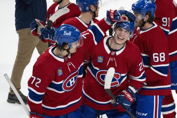 Montreal Canadiens' Juraj Slafkovsky, front right, and teammate Arber Xhekaj celebrate their victory over the Arizona Coyotes in NHL hockey game action in Montreal, Thursday, Oct. 20, 2022. (Paul Chiasson/The Canadian Press via AP)