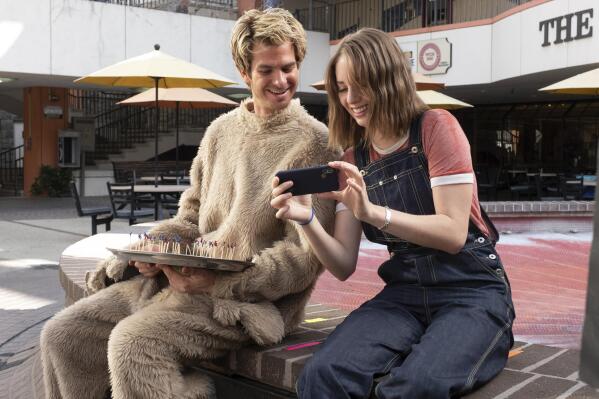 This image released by IFC Films shows Andrew Garfield, left, and Maya Hawke in a scene from "Mainstream," a film by Gia Coppola. (Beth Dubber/IFC Films via AP)
