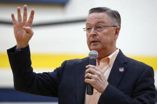 FILE - In this May 11, 2017, file photo, Rep. Rod Blum, R-Iowa, speaks during a town hall meeting in Marshalltown, Iowa. Blum has likely violated multiple House ethics rules by failing to disclose a new company that he founded, using an official photo on its website, and having an aide appear in a false testimonial for its services, a review by The Associated Press shows. Blum, a Republican facing a competitive race for re-election, is one of two directors of the Tin Moon Corporation, a digital marketing company incorporated in 2016 as Blum was in his first term, a business filing shows. (AP Photo/Charlie Neibergall, File)