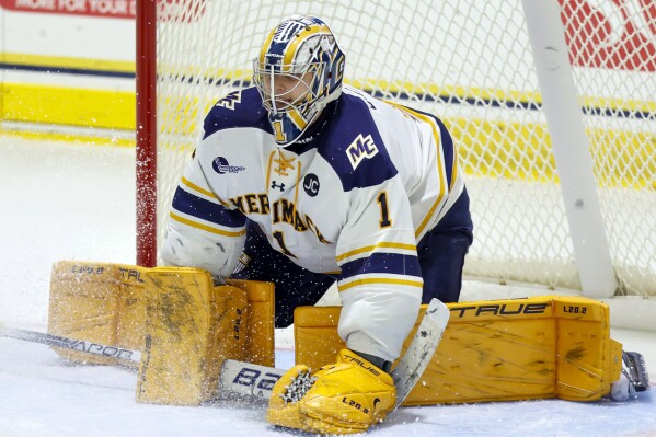 FILE - Merrimack College goalie Hugo Ollas (1) covers up the puck during the third period of an NCAA hockey game against Massachusetts on Saturday, Oct. 29, 2022, in North Andover, Mass. The New York Rangers have agreed to terms with Swedish goaltender Hugo Ollas on a two-year, entry-level contract, general manager Chris Drury announced Friday, March 15, 2024. Before attending Merrimack, Ollas appeared in 11 games in 2020-21 in the Swedish Hockey League. He also competed for the Swedish U17 team in international play. (AP Photo/Greg M. Cooper, File)