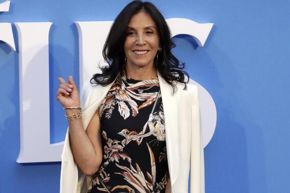 FILE - Olivia Harrison, widow of musician George Harrison, appears at the World premiere of the film "Eight days a week" in London on Sept. 15, 2016. Harrison released a book of poetry, "Came the Lightening: Twenty Poems for George." (AP Photo/Kirsty Wigglesworth, File)