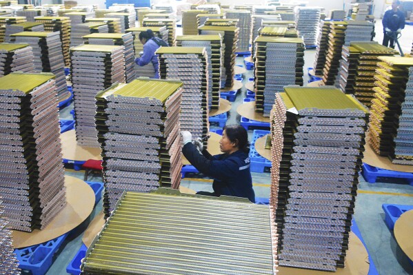 Workers labor at a factory of coolant radiators for air conditioners in Yuexi county in central China's Anhui province, on Feb. 21, 2024. Manufacturing in China contracted for a fifth consecutive month in February, according to an official survey of factory managers released Friday, March 1, 2024, reflecting persistent weakness in the economy ahead of annual legislative meetings where officials are expected to boost policy support. (Chinatopix via AP)