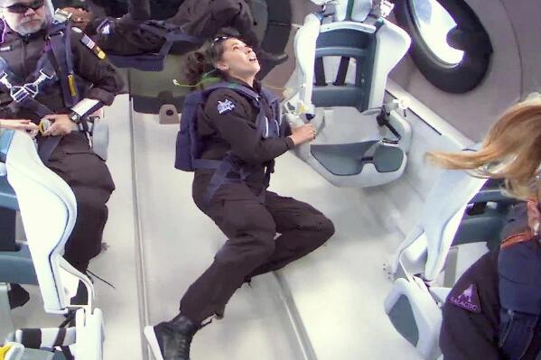 This photo released by Virgin Galactic shows mission specialist Jamila Gilbert, center, looking out one of the portal windows as she experiences weightlessness during a test flight on Thursday, May 25, 2023. Virgin Galactic completed what’s expected to be its final test flight Thursday before taking paying customers on brief trips to space. (Virgin Galactic via AP)