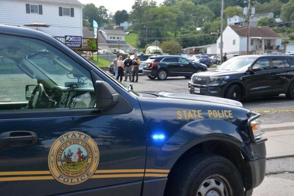 A heavy police presence is on scene of a Nutter Fort, W.Va. funeral home on Wednesday, Aug. 24, 2022, after an officer-involved shooting of a fugitive suspect occurred in the funeral home's parking lot. (Jonathan Weaver/The Exponent via AP)