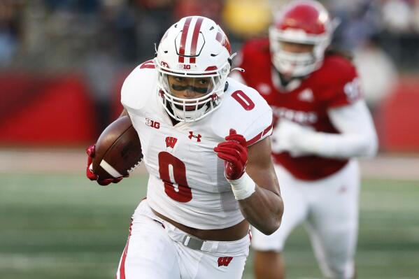FILE - Wisconsin running back Braelon Allen (0) rushes against Rutgers during the second half of an NCAA college football game, Saturday, Nov. 6, 2021, in Piscataway, N.J.  Allen looks like the next great Badgers back. After barely seeing the field in Wisconsin's first four games, he ended up running 1,106 yards and 7.06 per carry.(AP Photo/Noah K. Murray, File)