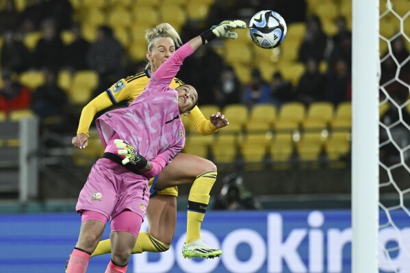 South Africa's goalkeeper Kaylin Swart punches the ball away from Sweden's Stina Blackstenius during the Women's World Cup Group G soccer match between Sweden and South Africa in Wellington, New Zealand, Sunday, July 23, 2023. (AP Photo/Andrew Cornaga)