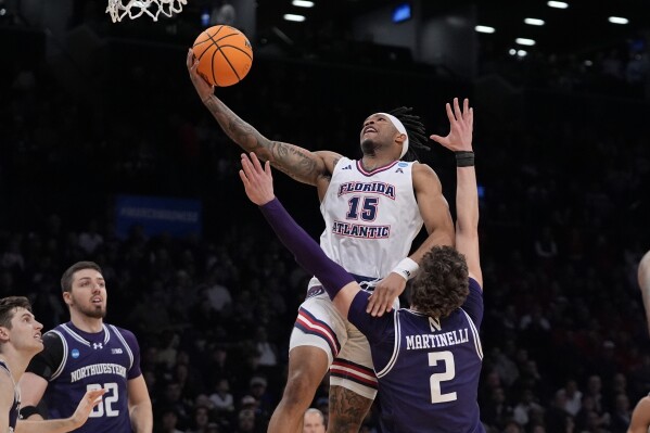 FILE - Florida Atlantic's Alijah Martin (15) drives past Northwestern's Nick Martinelli (2) during the first half of a first-round college basketball game in the NCAA Tournament, Friday, March 22, 2024, in New York. Florida Atlantic standout Martin, who helped propel the Owls to the Final Four in 2023, is moving about 300 miles north to play at Florida. The 6-foot-2 guard formally signed with the Gators on Monday, April 22, and is expected to become an immediate starter for coach Todd Golden in Gainesville. (AP Photo/Frank Franklin II, File)